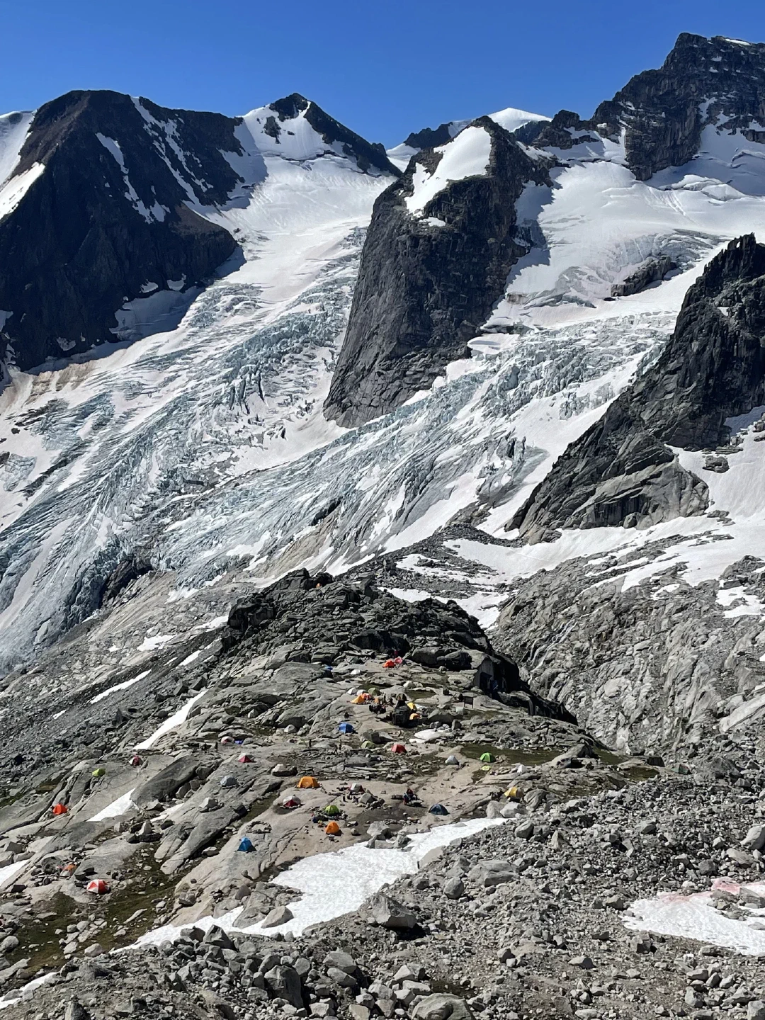 Applebee camp from above, tents scattered across granite shelves beneath Houndstooth icefall