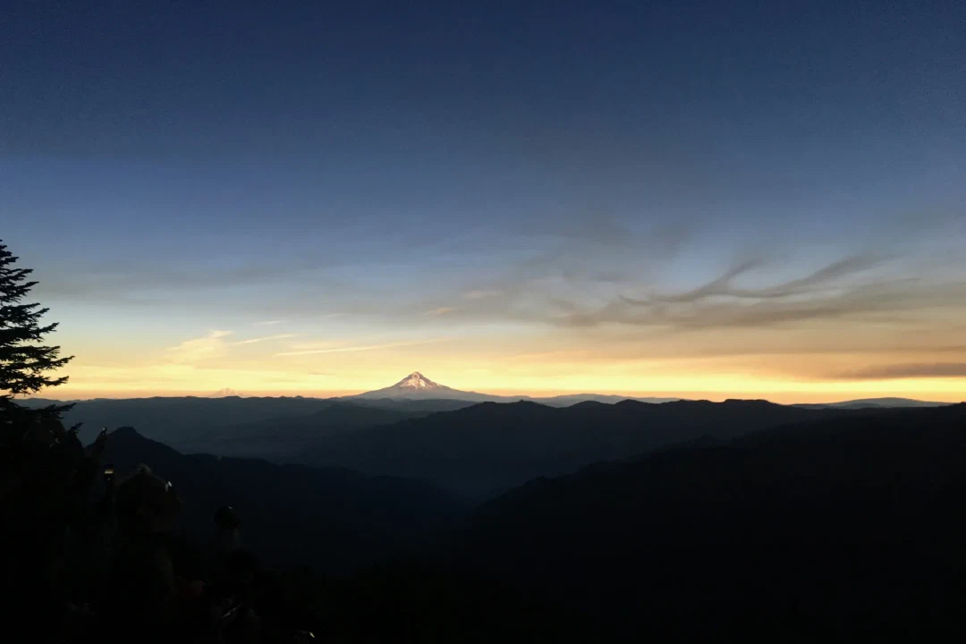 Sunset colors ringing the eclipse shadow, glowing on the slopes of Mt Hood. A bit off its left shoulder, Mt Adams peeks over the horizon.