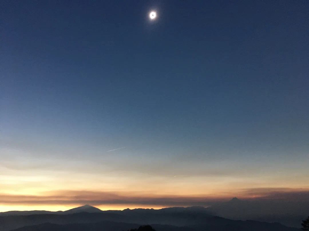 Totality. Corona flare around the moon above Mt Jefferson.