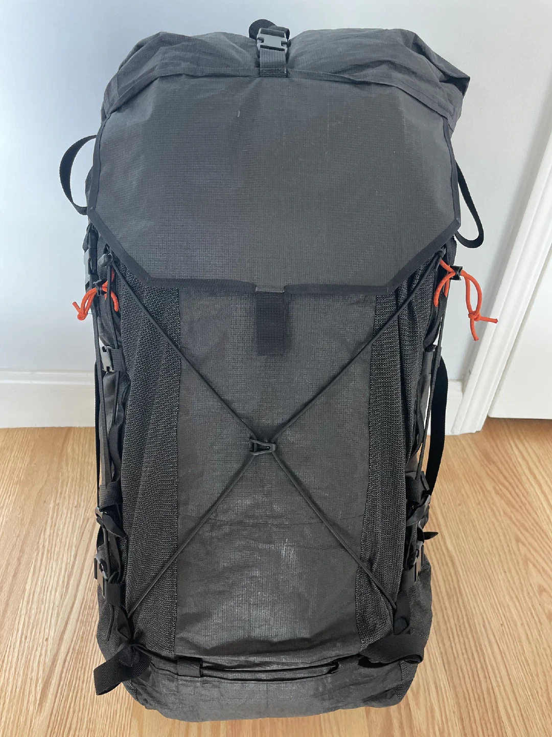 The finished pack standing upright, bungee crossed over the front pocket.