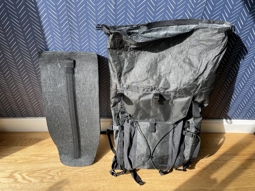 Removable padded framesheet and contoured aluminum stay sheath, standing beside the empty pack