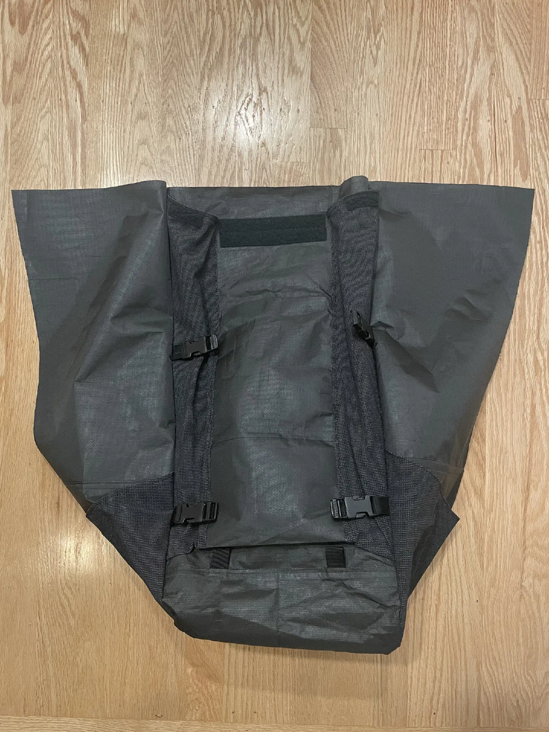 The assembled front pocket, main body side walls, and side pockets with webbing buckles attached.