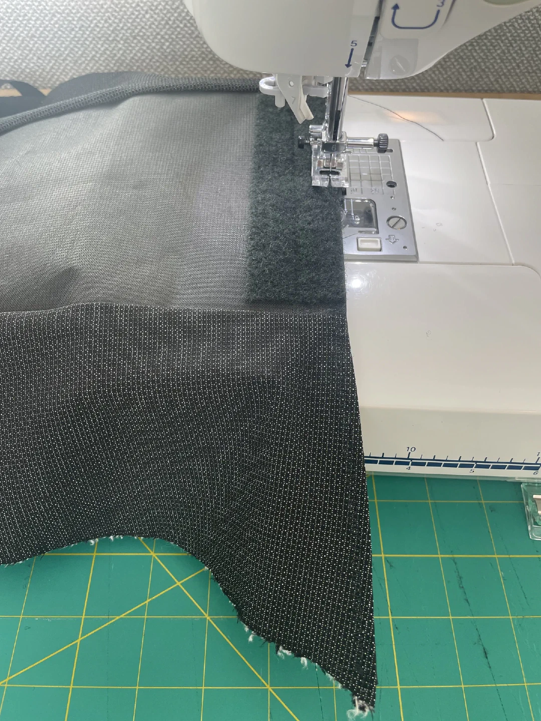 Feeding front pocket through the sewing machine.