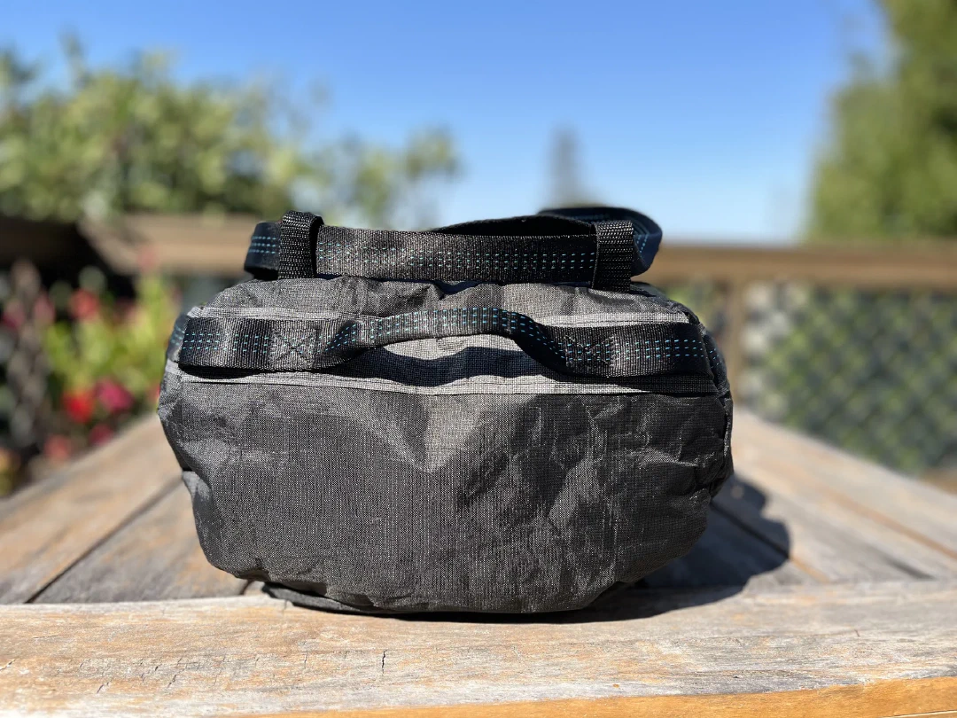End view of the first version: grab handles and the strap crossing over