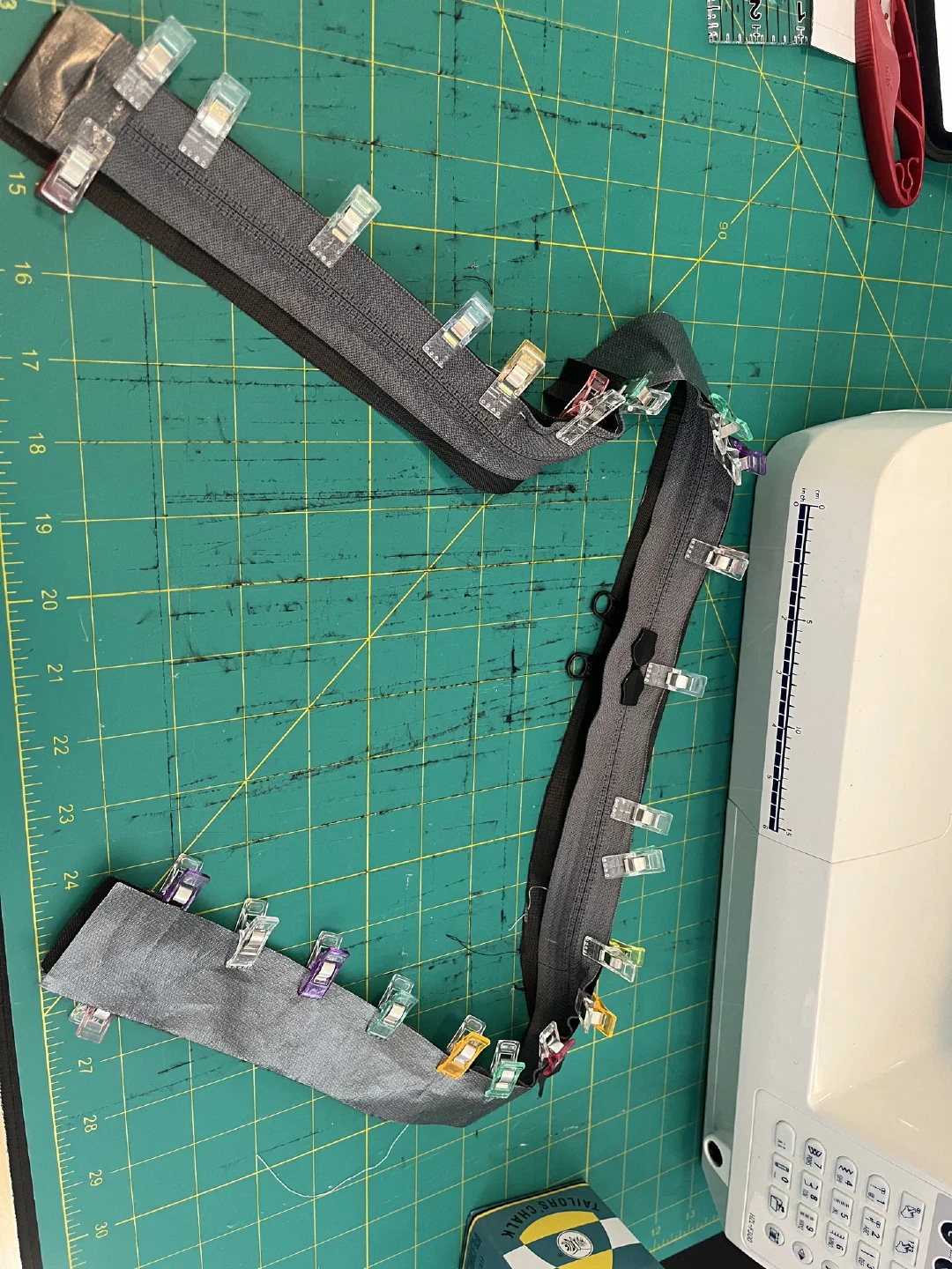 The main zipper clipped around its curve, ready to sew