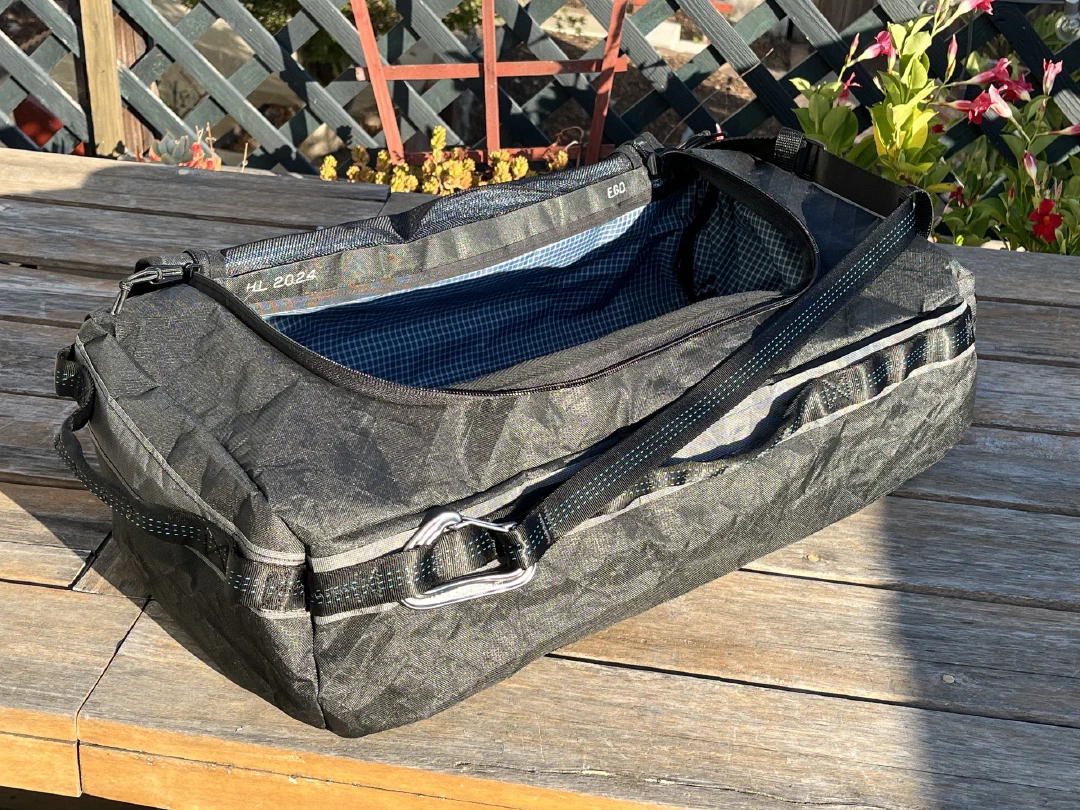 The finished duffle on a deck table, lid unzipped to show the blue liner.